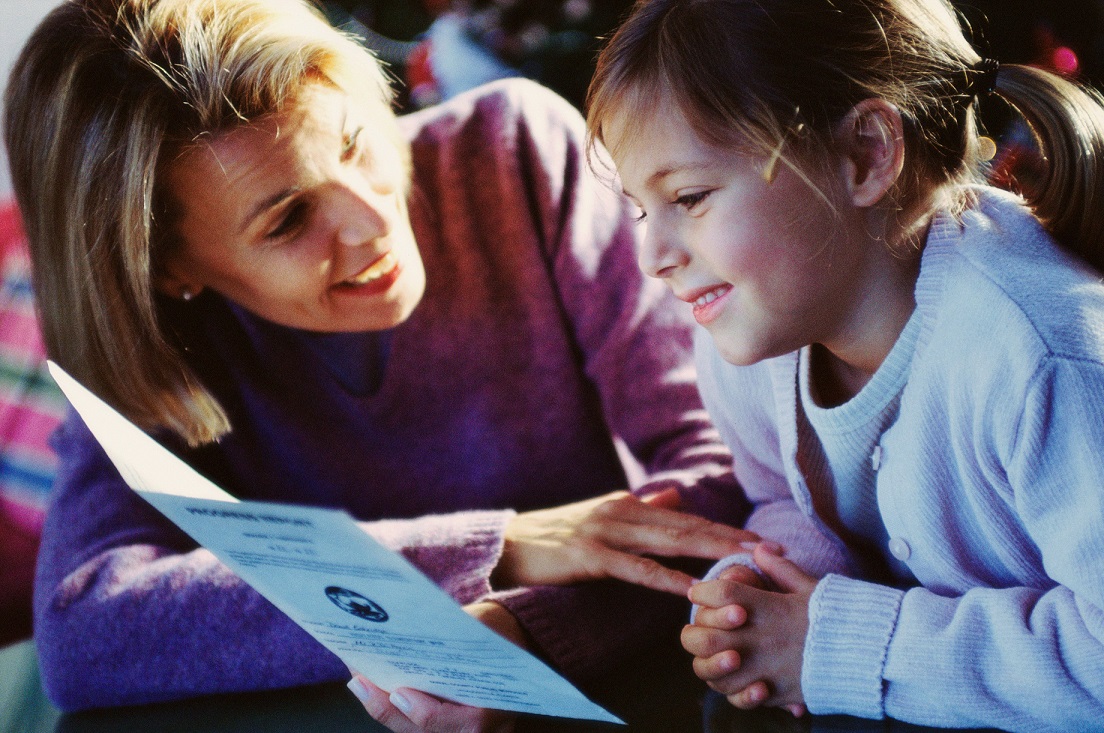 mother helping her daughter read